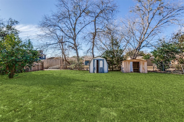 view of yard with a fenced backyard, an outdoor structure, and a storage shed