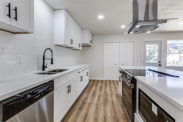 kitchen with range with electric stovetop, a sink, light countertops, stainless steel dishwasher, and island exhaust hood