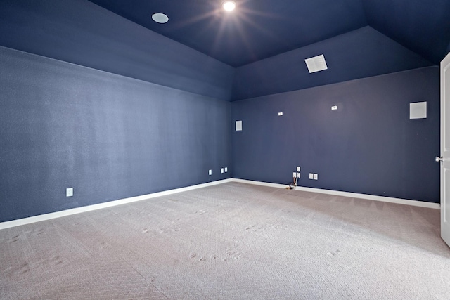 unfurnished room with vaulted ceiling and carpet flooring