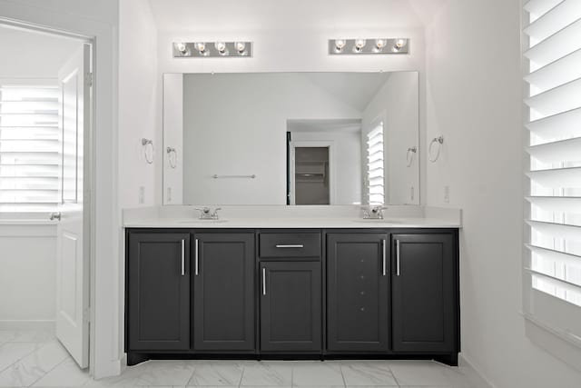 bathroom featuring lofted ceiling and vanity