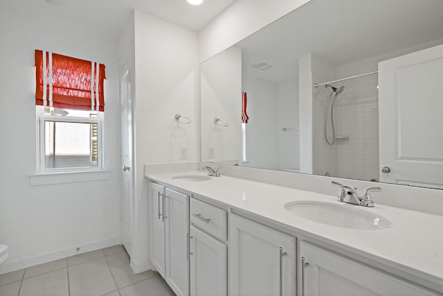 bathroom with vanity, tile patterned floors, and toilet