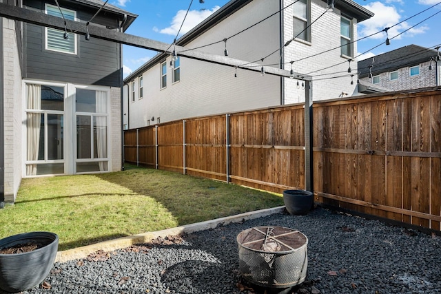 view of yard with an outdoor fire pit