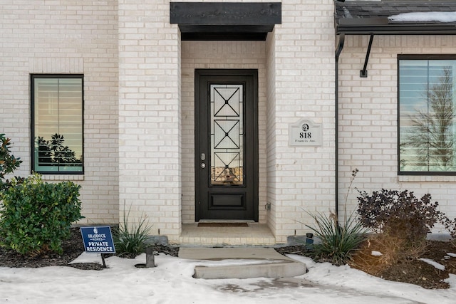 view of snow covered property entrance