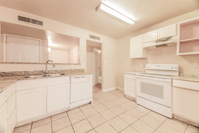 kitchen featuring white appliances, light tile patterned floors, a textured ceiling, white cabinets, and sink