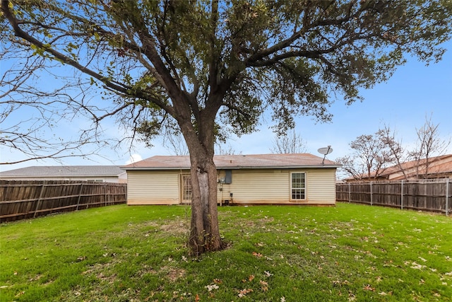 back of property featuring a lawn