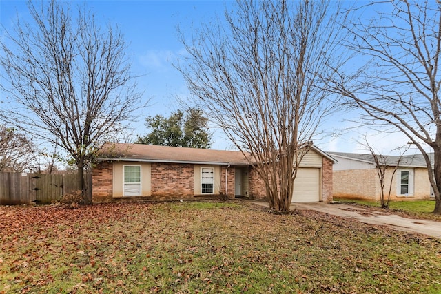 single story home with a front yard and a garage