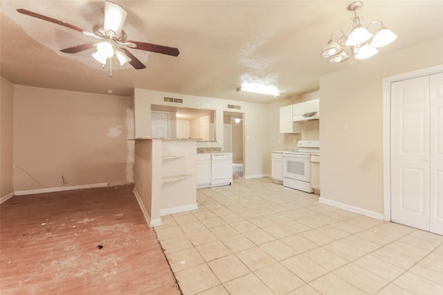 kitchen featuring white appliances, kitchen peninsula, light stone counters, white cabinetry, and ceiling fan with notable chandelier