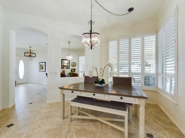 dining space with a notable chandelier and crown molding