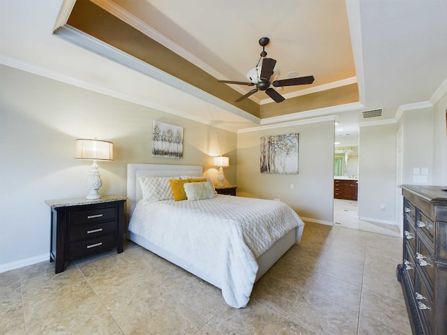 bedroom featuring ensuite bathroom, ceiling fan, a tray ceiling, and ornamental molding