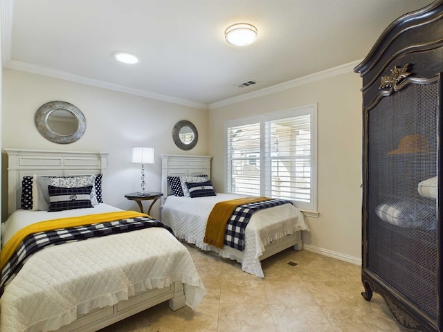 bedroom with ornamental molding and light tile patterned floors