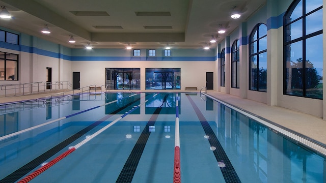 view of pool at dusk