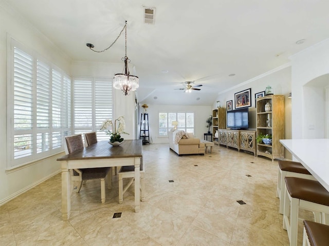 dining space with ornamental molding and ceiling fan with notable chandelier