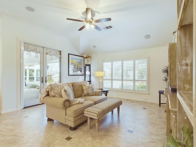 living room featuring ceiling fan and french doors