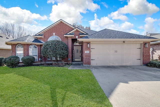 view of front facade with a front yard and a garage