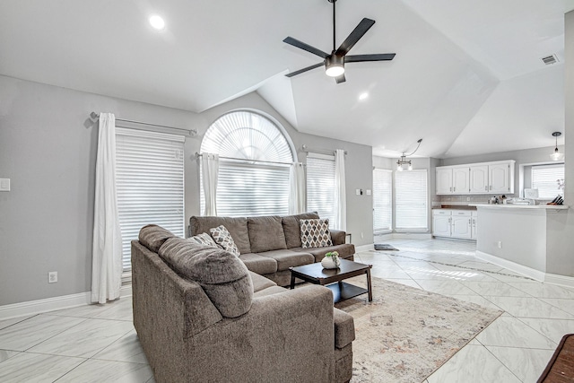 living room with ceiling fan and lofted ceiling