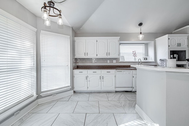 kitchen with white cabinetry, dishwasher, lofted ceiling, backsplash, and hanging light fixtures