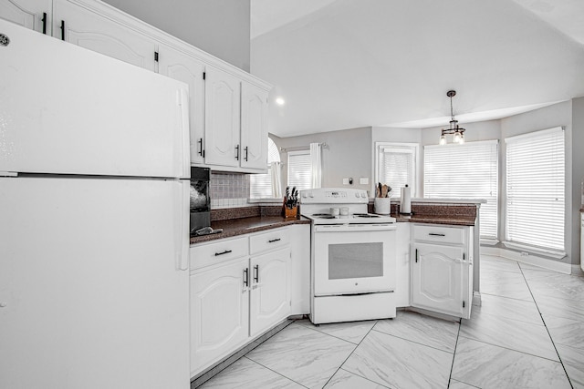 kitchen featuring white cabinetry, white appliances, kitchen peninsula, decorative backsplash, and a notable chandelier