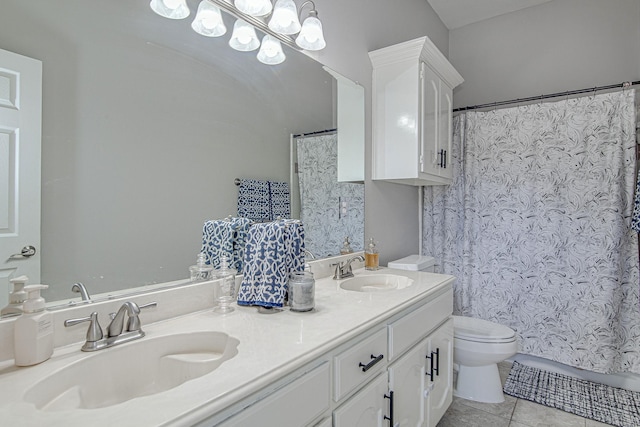 bathroom with toilet, tile patterned floors, and vanity