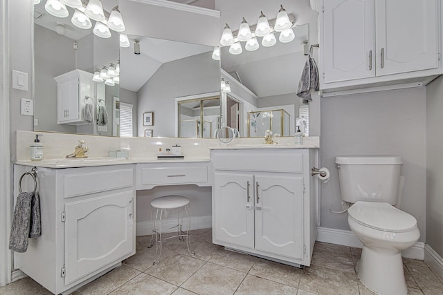 bathroom featuring vanity, vaulted ceiling, tile patterned floors, and toilet