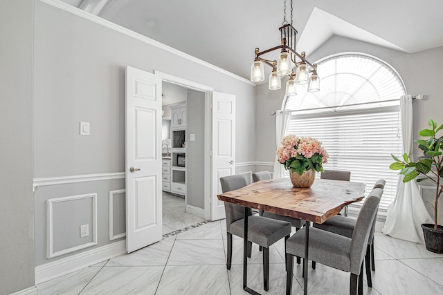 dining room with lofted ceiling, a notable chandelier, and crown molding