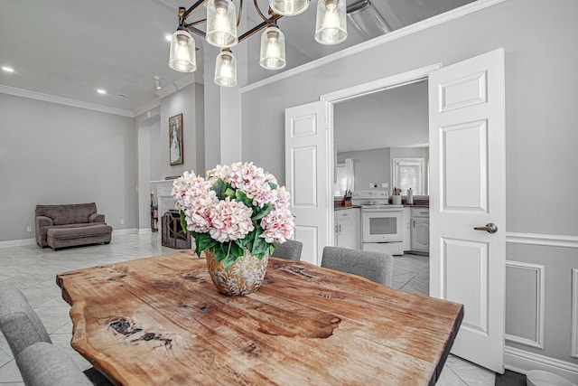 dining area with light tile patterned floors, a notable chandelier, and crown molding