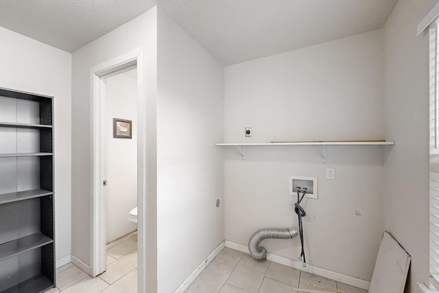 laundry room featuring hookup for an electric dryer, hookup for a washing machine, and light tile patterned floors