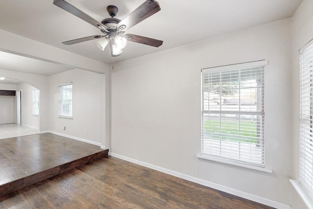 unfurnished room featuring dark hardwood / wood-style flooring and ceiling fan