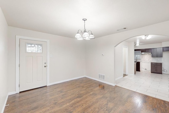 foyer featuring light hardwood / wood-style flooring and a chandelier