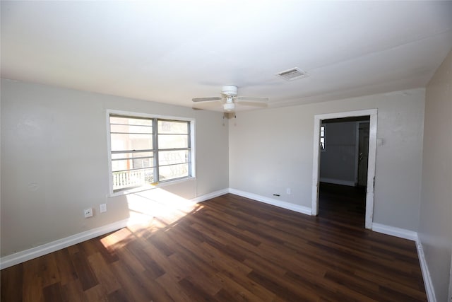 spare room with ceiling fan and dark hardwood / wood-style floors