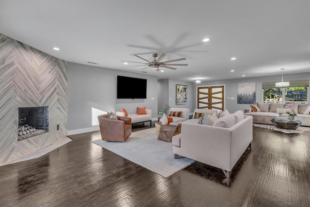 living room featuring dark hardwood / wood-style flooring and ceiling fan