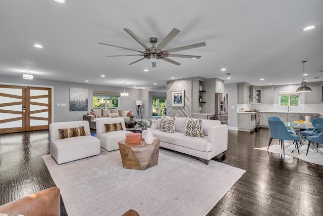 living room with ceiling fan and hardwood / wood-style flooring