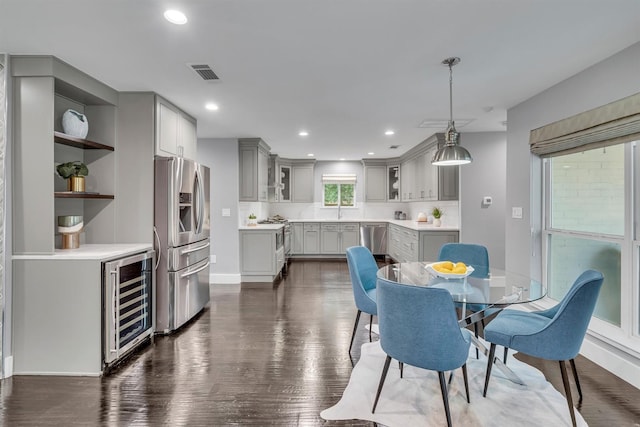 dining area featuring beverage cooler and dark hardwood / wood-style floors