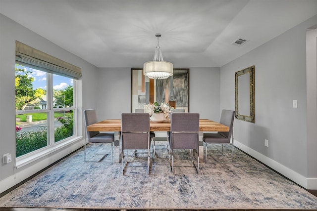 dining area featuring an inviting chandelier and plenty of natural light