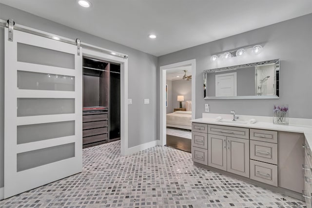 bathroom with built in features, ceiling fan, and vanity