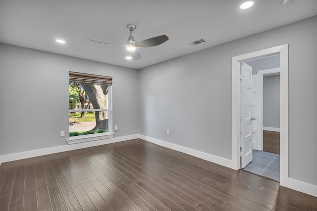 spare room featuring ceiling fan and dark hardwood / wood-style floors