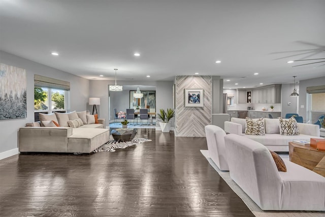 living room with ceiling fan and dark hardwood / wood-style floors