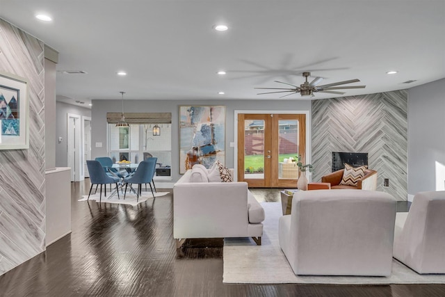 living room featuring a fireplace, ceiling fan, french doors, and a healthy amount of sunlight