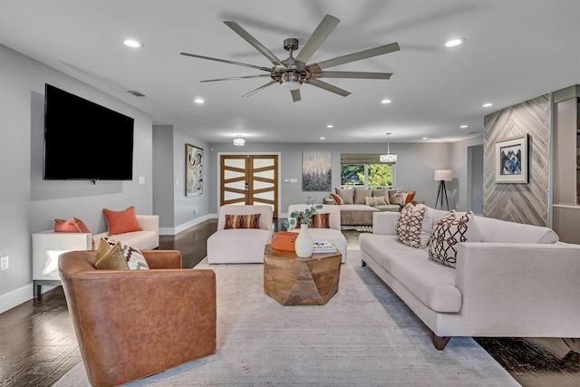 living room with ceiling fan and wood-type flooring