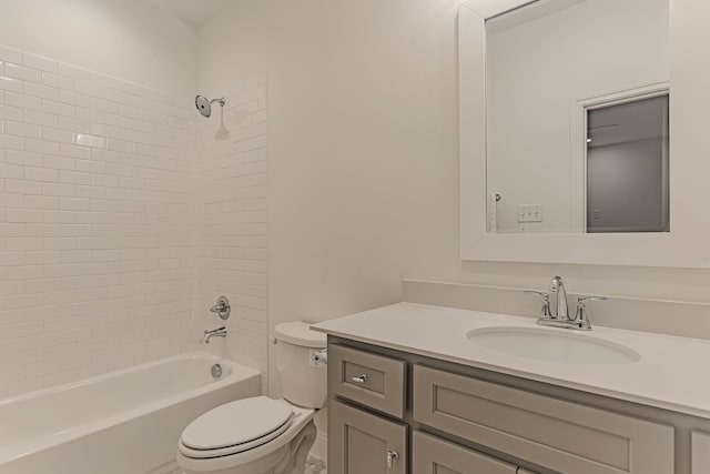 full bathroom with toilet, tiled shower / bath combo, and vanity