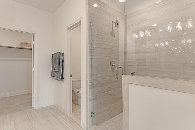 bathroom with toilet and an enclosed shower