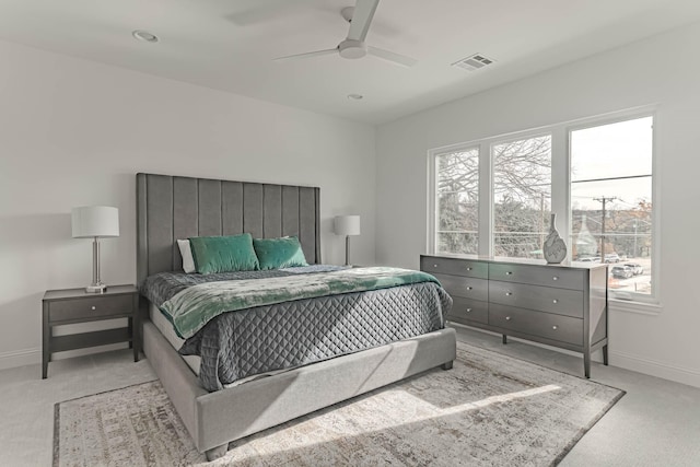 bedroom featuring light carpet and ceiling fan