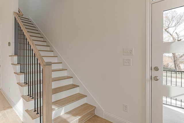 staircase with wood-type flooring