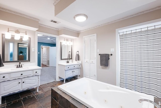 bathroom featuring a relaxing tiled tub, ornamental molding, and vanity