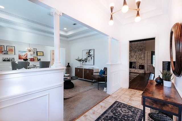 interior space featuring decorative columns and a stone fireplace