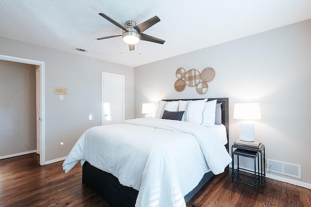 bedroom featuring a textured ceiling, ceiling fan, and dark hardwood / wood-style floors