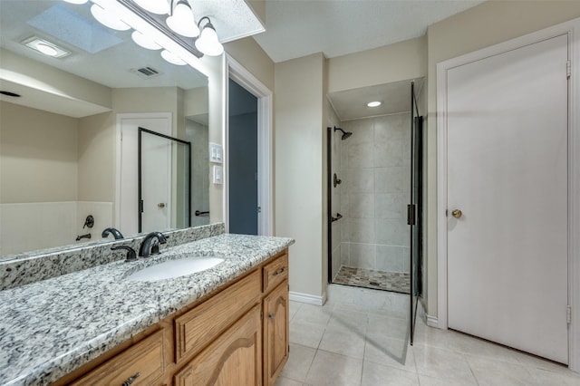 bathroom with vanity, tile patterned flooring, and a shower with shower door