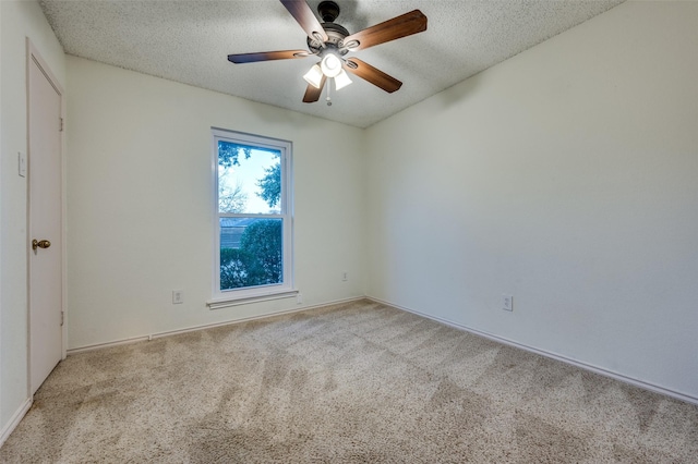 carpeted empty room with a textured ceiling and ceiling fan