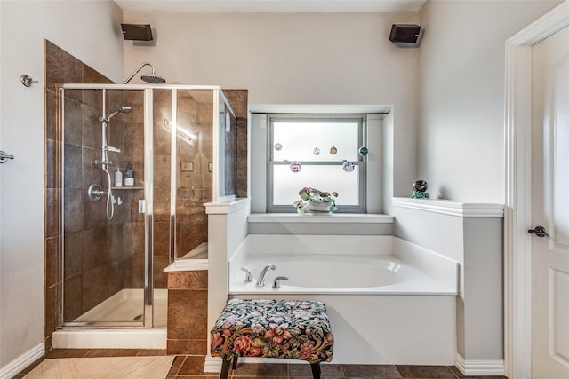 bathroom featuring separate shower and tub