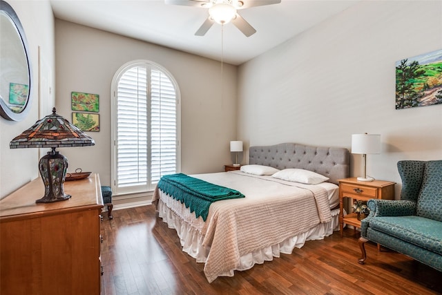 bedroom featuring ceiling fan, dark hardwood / wood-style flooring, and multiple windows