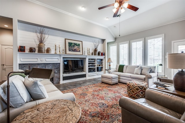 living room with a fireplace, ceiling fan, vaulted ceiling, and ornamental molding